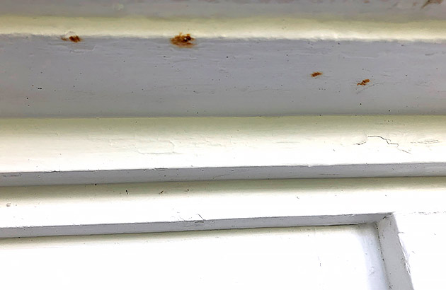 A steel lintel over a window showing signs of rust