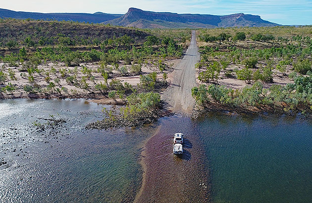 A 4WD with a caravan crossing a river