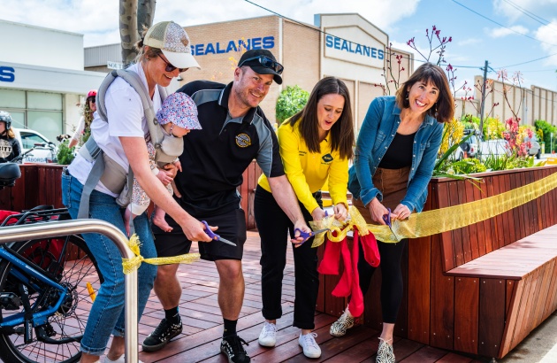 People cutting ribbon to open new bike hub