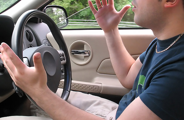 A driver raises his hands to signal his annoyance