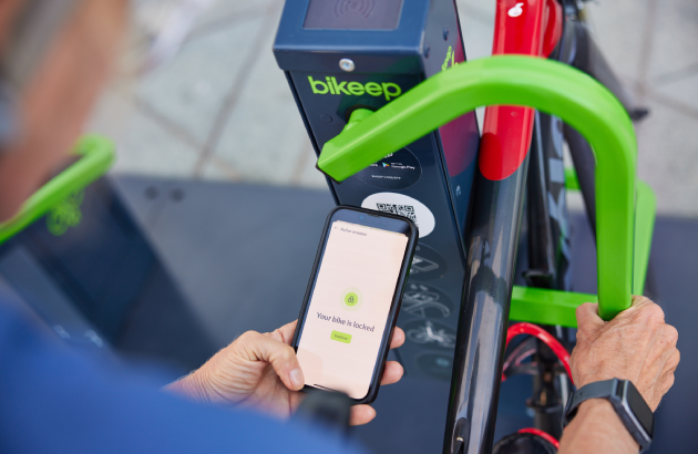 Someone using the Bikeep app to access the Smart Bike Hub.