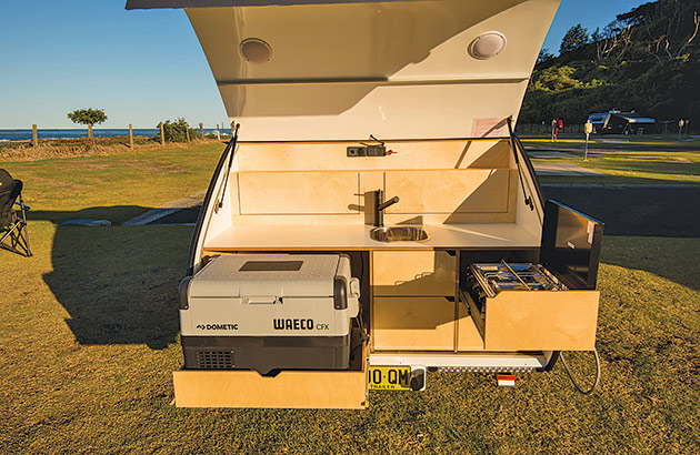 The extendable kitchen set-up in the rear of a teardrop camper