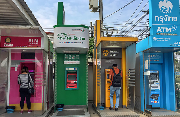 A row of colourful ATM machines on a street