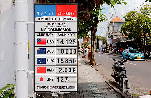 A currency exchange board on a street in Bali