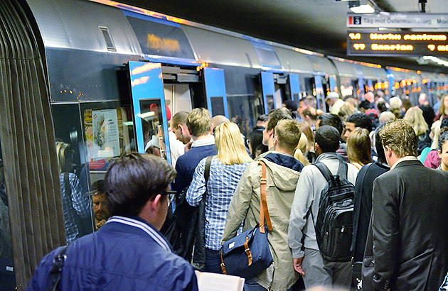 A crowd of commuters getting onto a train