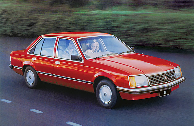 A red 1978 Holden Commodore on a country road