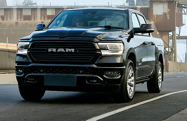 A black Ram Silverado on the road in an industrial area