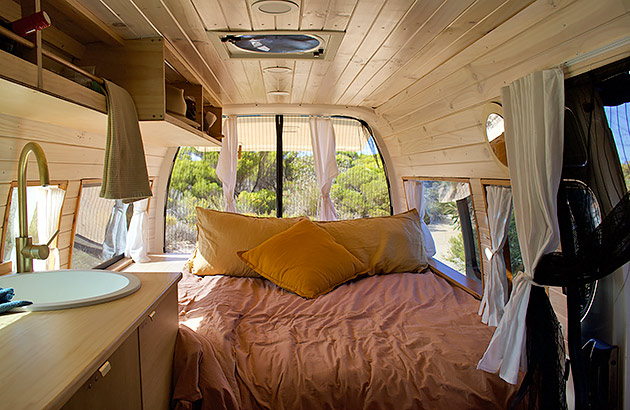 The interior of a campervan showing the bed