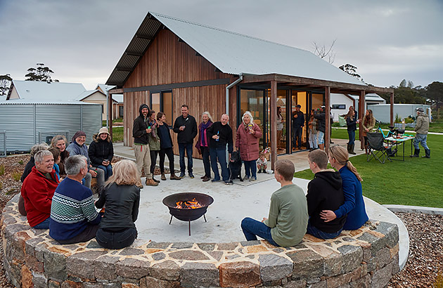 A group of people at a social gathering around a firepit