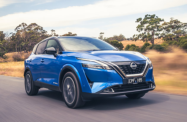 A blue Nissan Qashqai on a country road