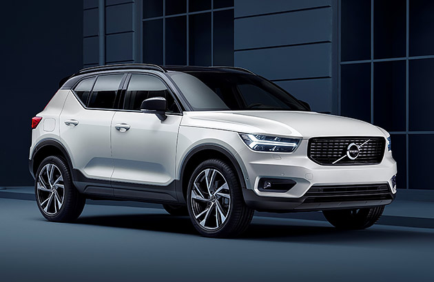 A white Volvo XC40 parked on a dark city street