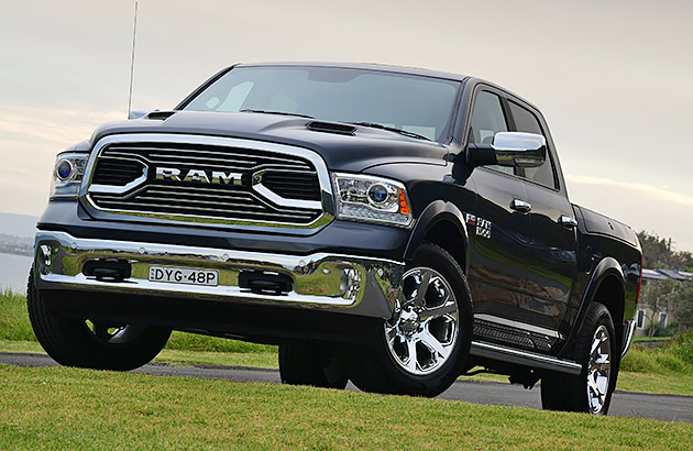 A black RAM Laramie parked on a grassed surface