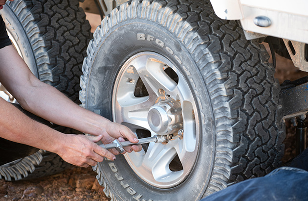 A caravan's wheel nuts being tightened