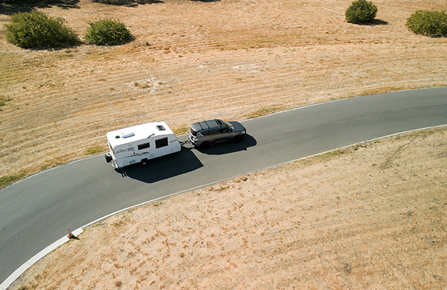 A 4WD towing a caravan on a road