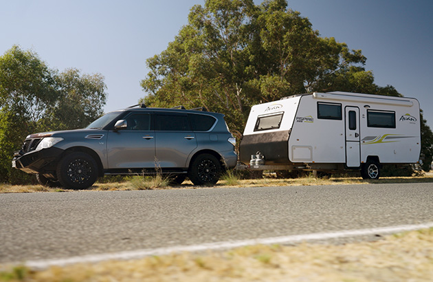 A Nissan Patrol with a caravan hitched to it
