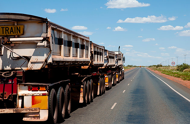 A rear view of a road train on a country road