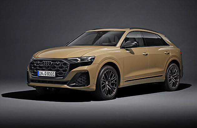 A brown Audi Q8 in a dark studio setting