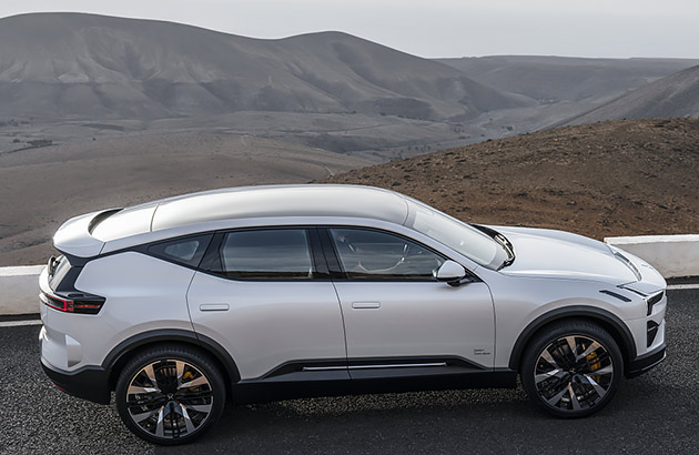 A white Polestar 3 parked on a roadside in a mountainous region