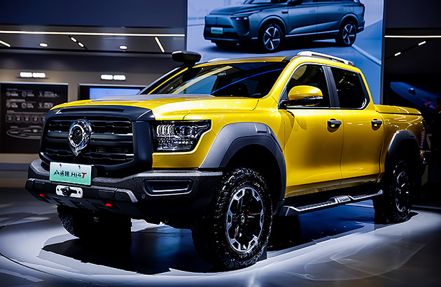 A yellow GWM Cannon Alpha PHEV in a showroom