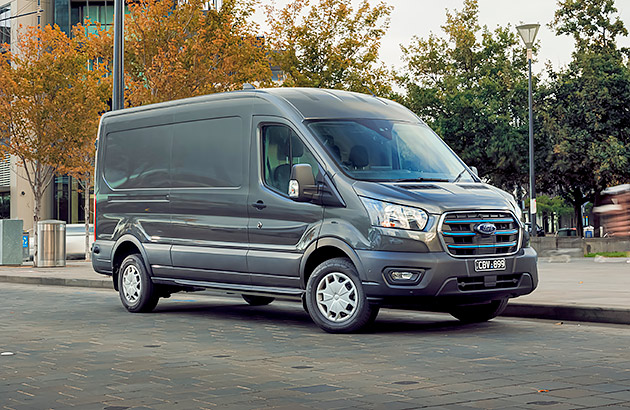 A black Ford eTransit van parked on a city street