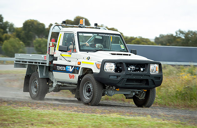 A white Land Cruiser 70 Series converted to an EV