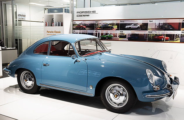 A blue Porsche 356 in a showroom