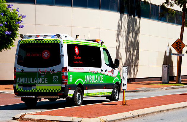 An ambulance drives down a city street