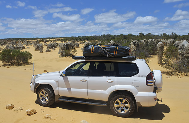 A Toyota Landcruiser driving on sand