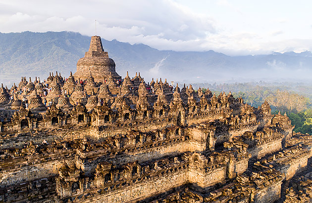 An expansive complex of temples with mountains in the distance