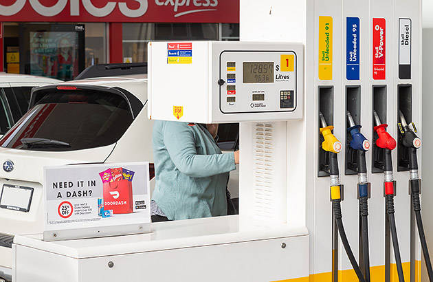 A car on the other side of a fuel bowser