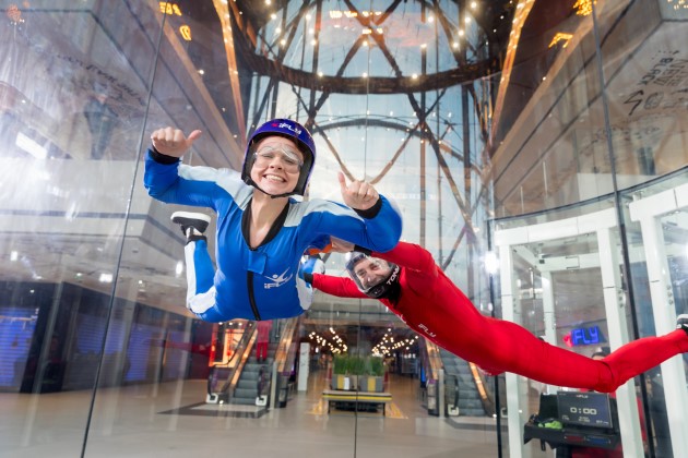 Two people mid-flight at iFly