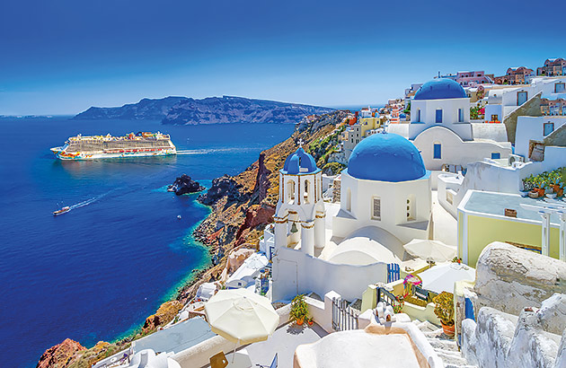 A cruise ship seen in the distance from a hillside of a Greek Island