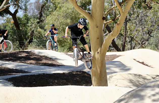 A young mountain bike rider in the air at the Dianella MTB park