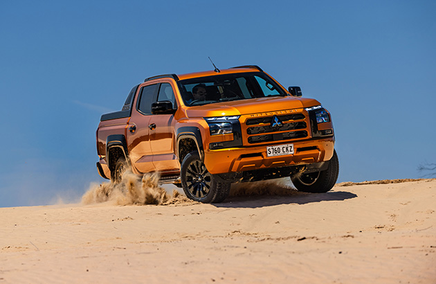 The 2024 Mitsubishi Triton driving on sand