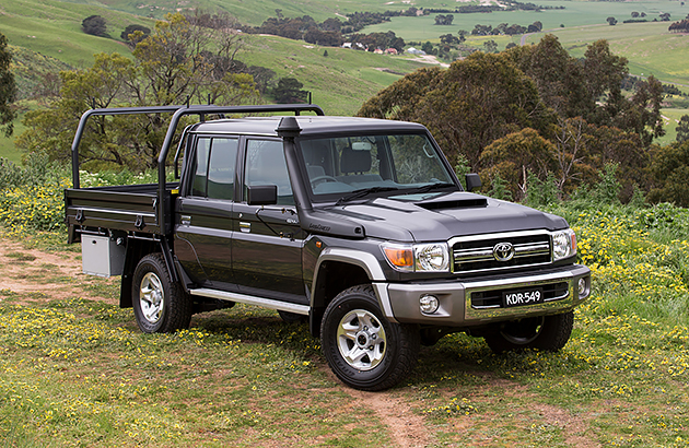 A black Toyota Landcruiser 70 series on a farm