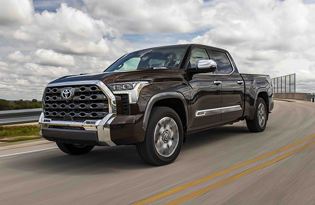 A black Toyota Tundra travelling on a country road