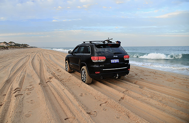 A four-wheel drive on a beach track