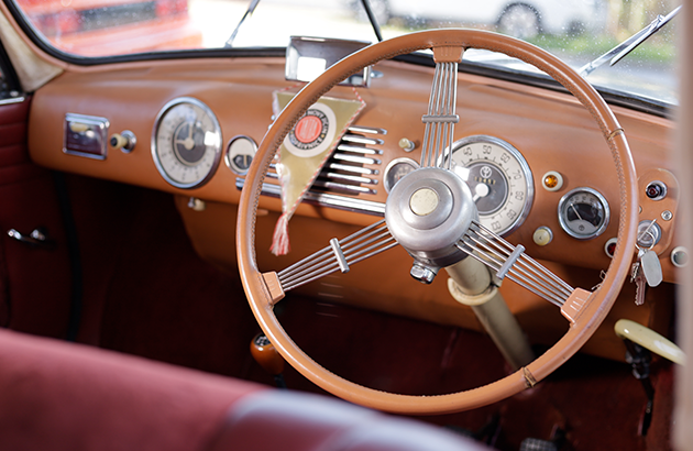 The stylish dashboard and steering wheel of a 1952 Tatra