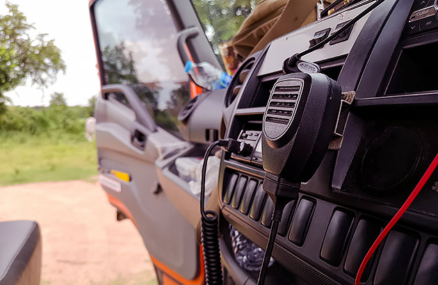 A close-up of car interior with a UHF radio in the dashboard