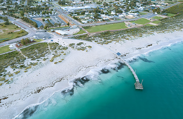 An aerial photo of the beach at Jurien Bay including the curved jetty