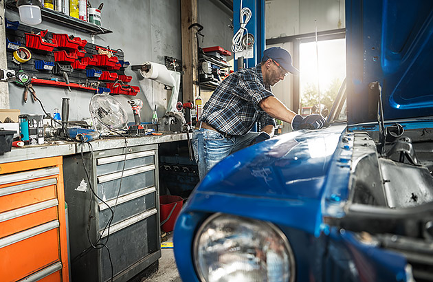 A person working on a car in a workshop