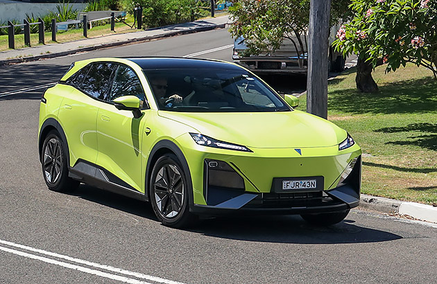 A bright green Deepal S07 driving on a suburban road