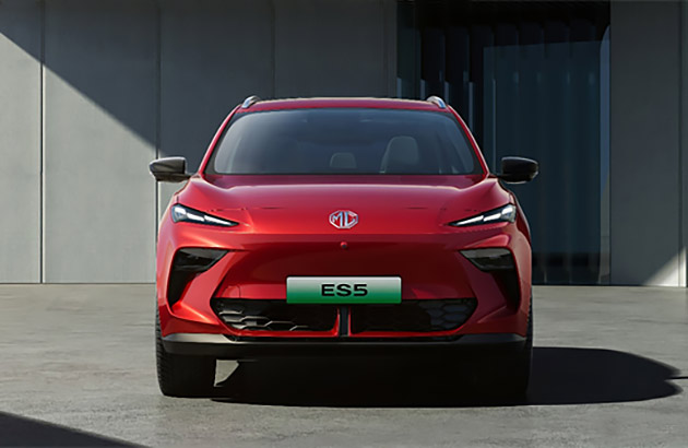 A red MG ES5 parked on concrete