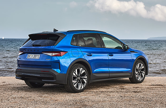 A blue Skoda Elroq parked near the beach