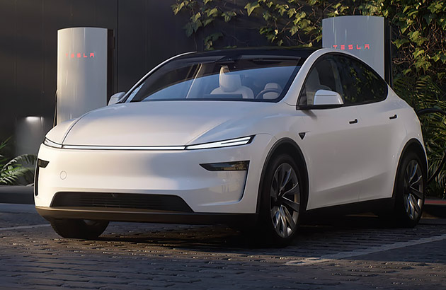 A white Tesla Model Y parked near Tesla chargers