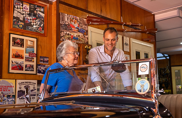 Alex and Mary Ann take a look at the 1947 MG TC parked in the garage