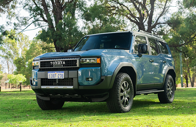 Blue 2024 Toyota Prado parked on grass