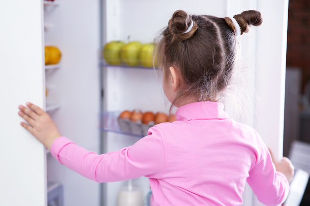Image of child opening fridge