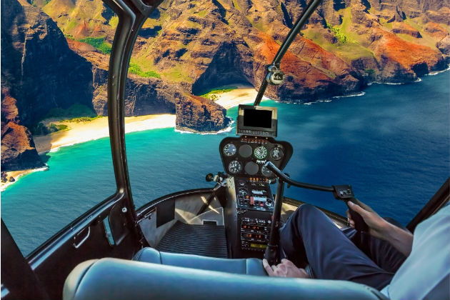 A view from a helicopter cockpit overlooking some cliffs