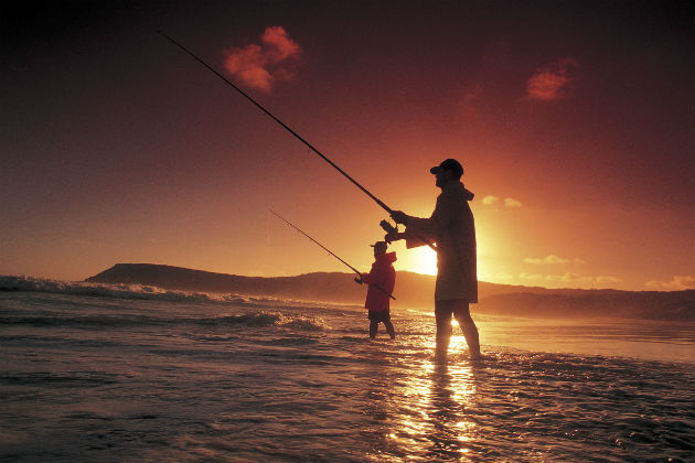 Fishing while wading in the ocean